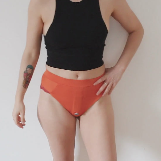 video showing a girl wearing an orange classic lingerie harness
