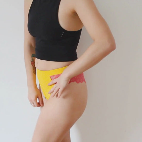 video showing a girl wearing a yellow brazilian lingerie harness